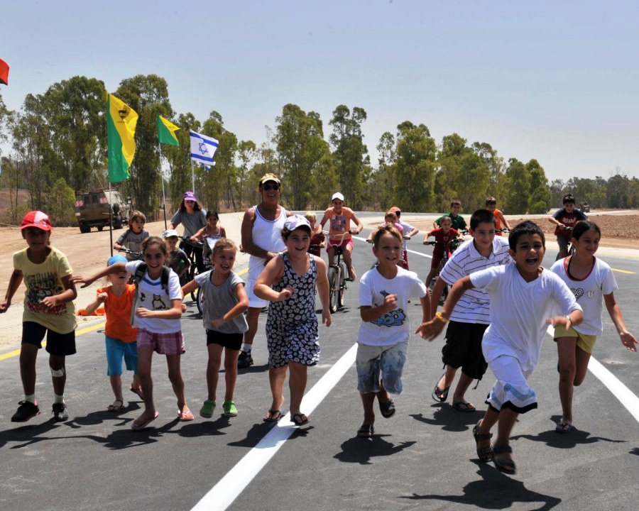 Israeli children running on road